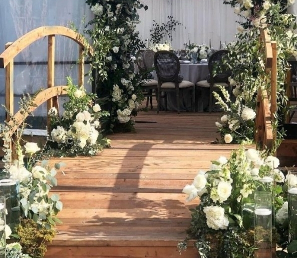 Wood flooring beneath a floral event ceremony installation
