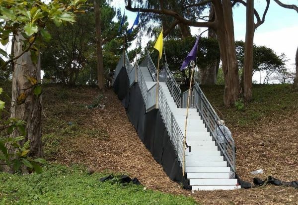 Temporary staircase with handrails on a landscaped slope