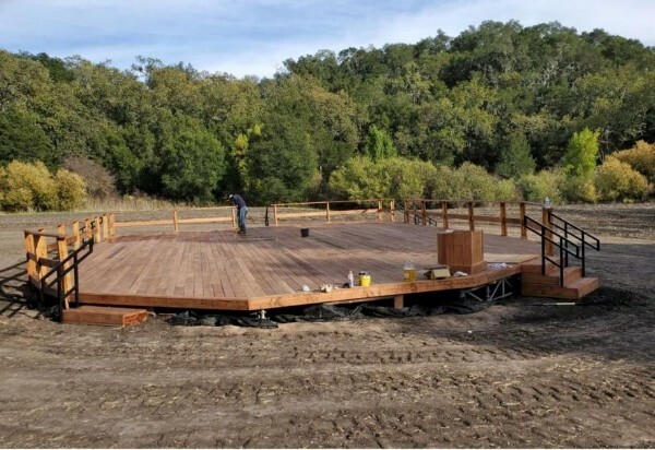 Round raised wood platform installed in an outdoor setting