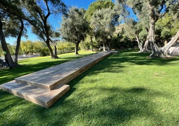 Temporary wood walkway through a landscaped outdoor venue